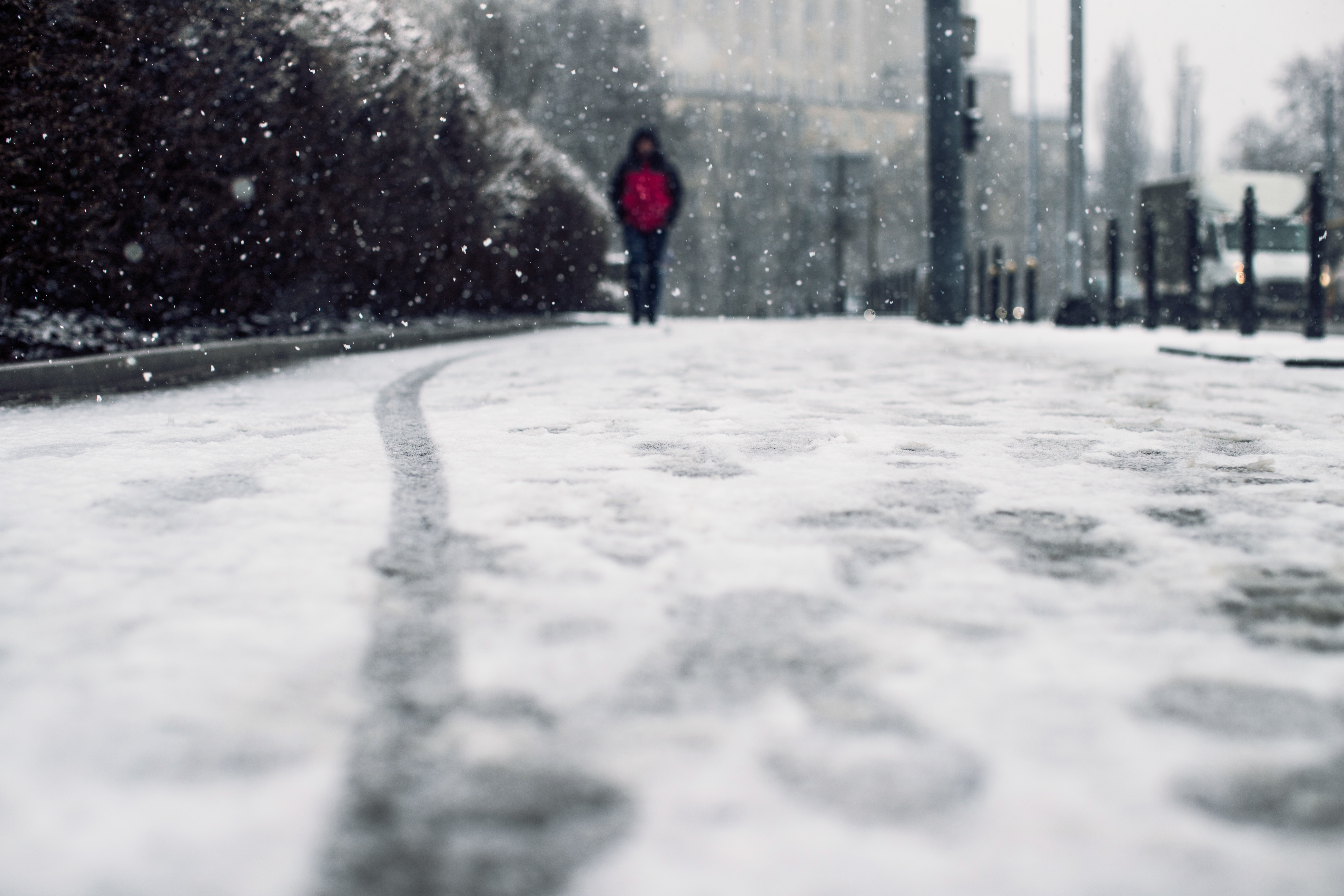 low-angle-shot-person-walking-snow-covered-sidewalk-snow (1).jpg
